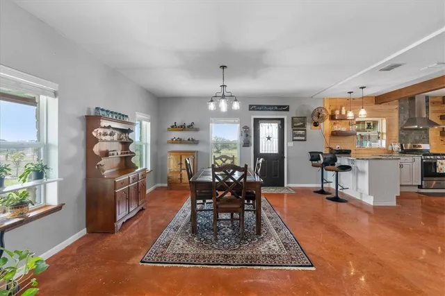 a living room with fireplace furniture and a chandelier