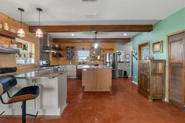 a view of a kitchen with refrigerator and cabinets