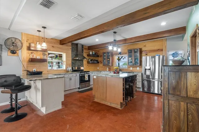 a kitchen with a sink appliances and cabinets