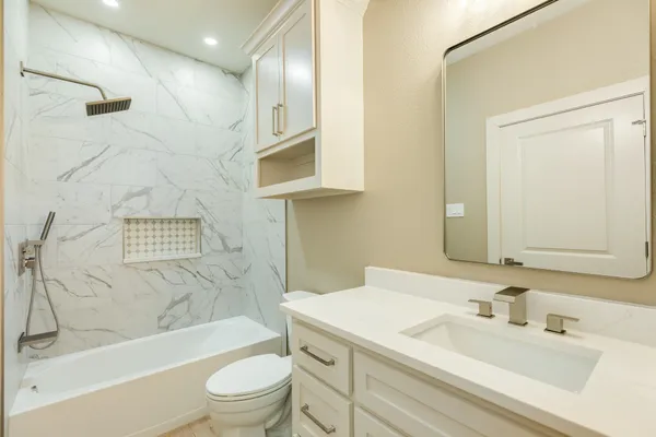a bathroom with a sink a toilet and a bathtub