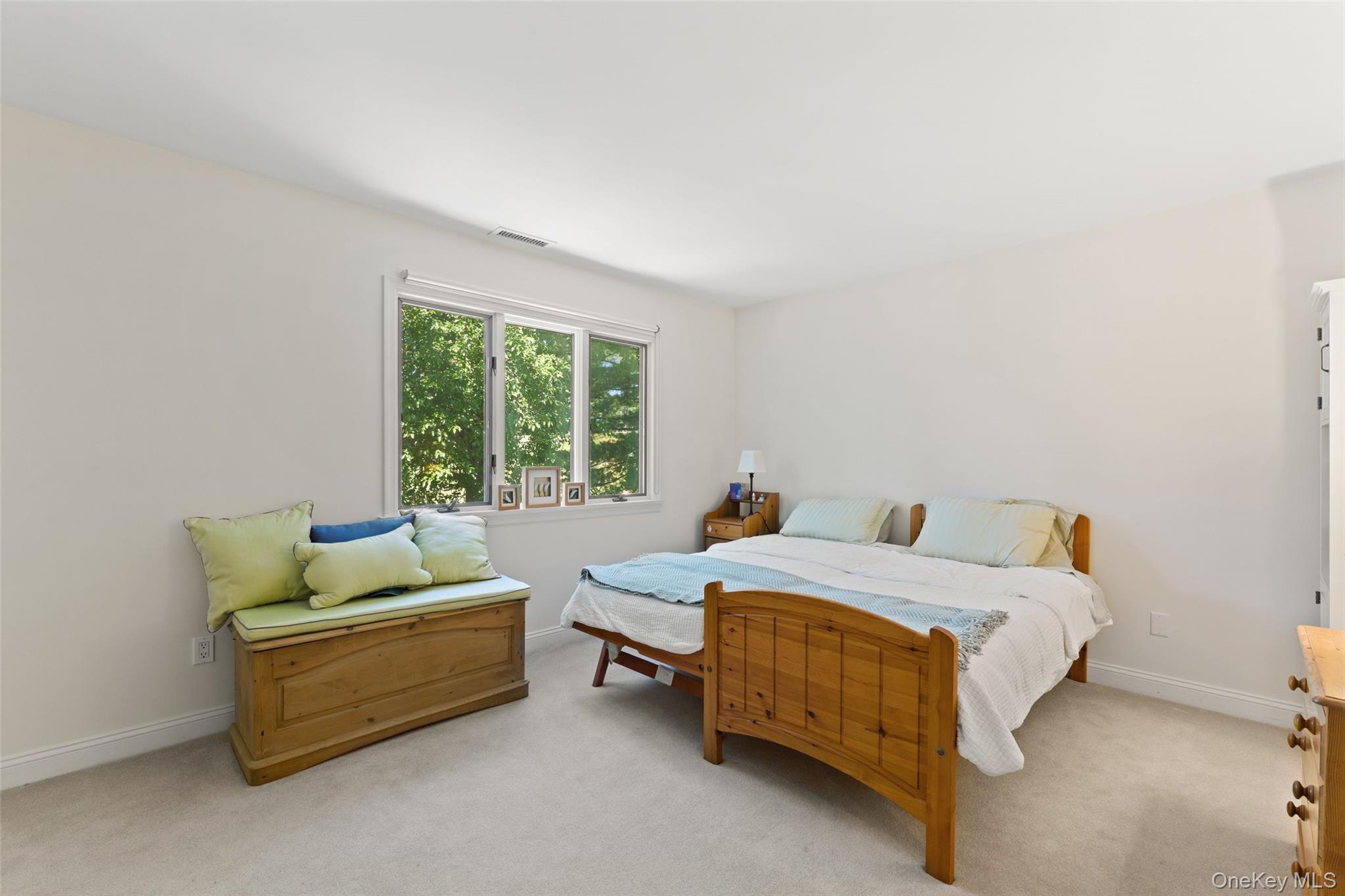 6 Magnetti Circle Mamaroneck, NY 10543 - Photo 16 of 24 a bed sitting in a bedroom next to a window with lamp