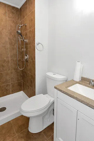 a bathroom with a toilet and a shower