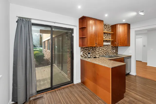 a view of kitchen with stainless steel appliances granite countertop wooden cabinets and a counter top space