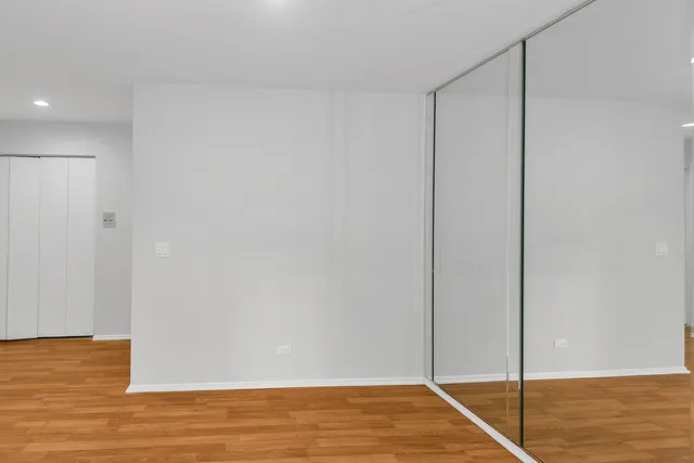 a view of a room with wooden floor