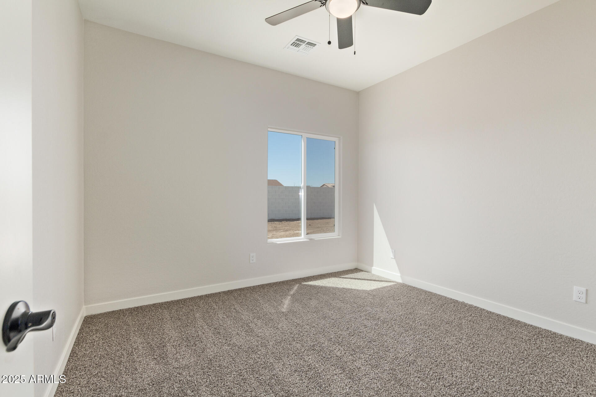 15220 South Diablo Road Arizona City, AZ 85123 - Photo 13 of 32 an empty room with a chandelier fan and windows