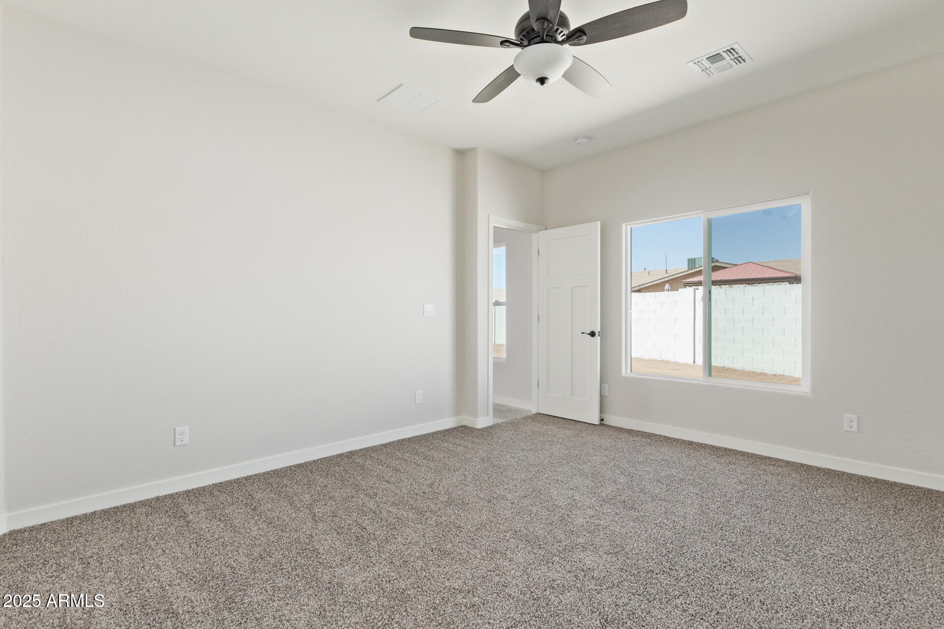 15220 South Diablo Road Arizona City, AZ 85123 - Photo 14 of 32 an empty room with a window and a fan