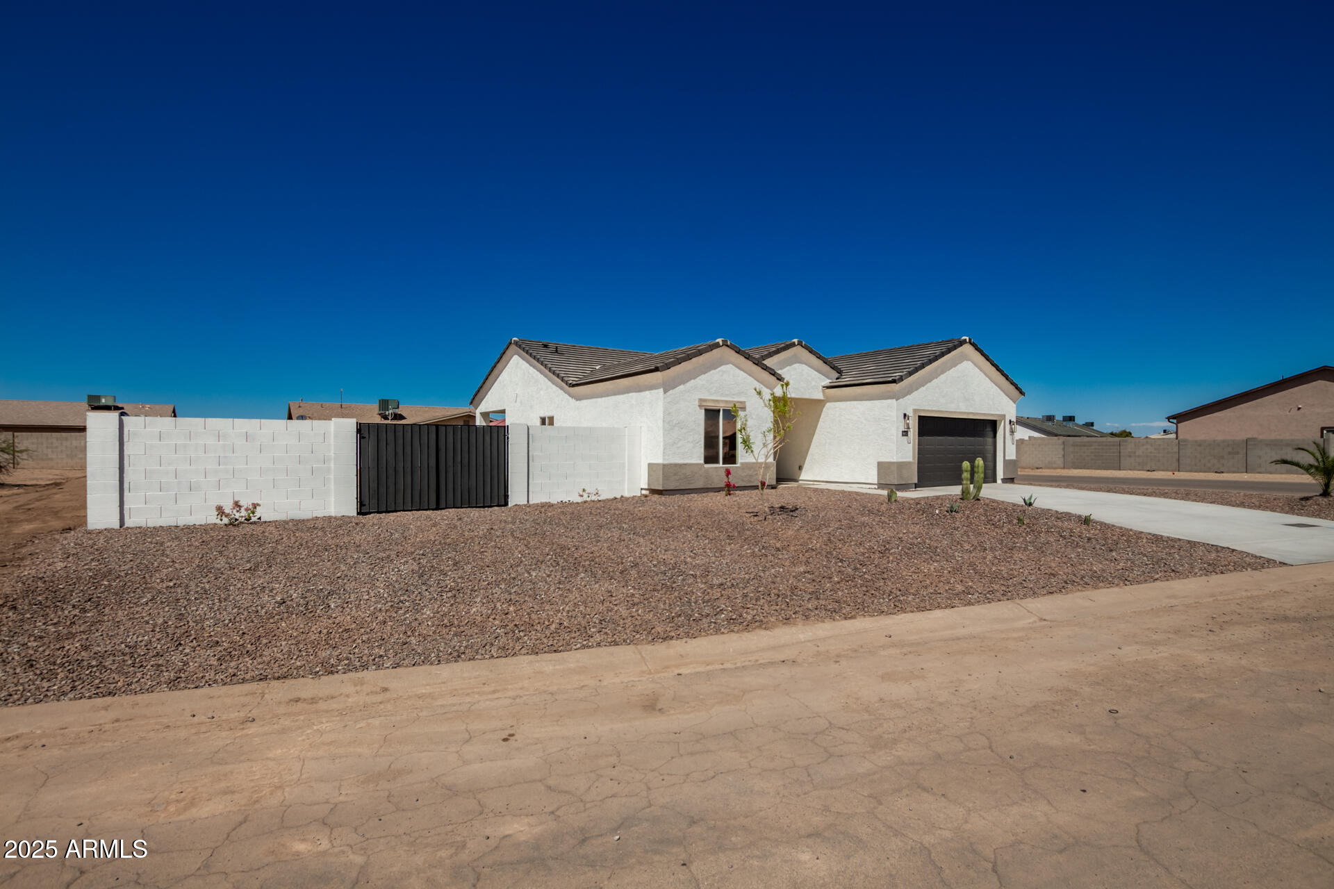 15220 South Diablo Road Arizona City, AZ 85123 - Photo 4 of 32 a view of white house with a yard and garage