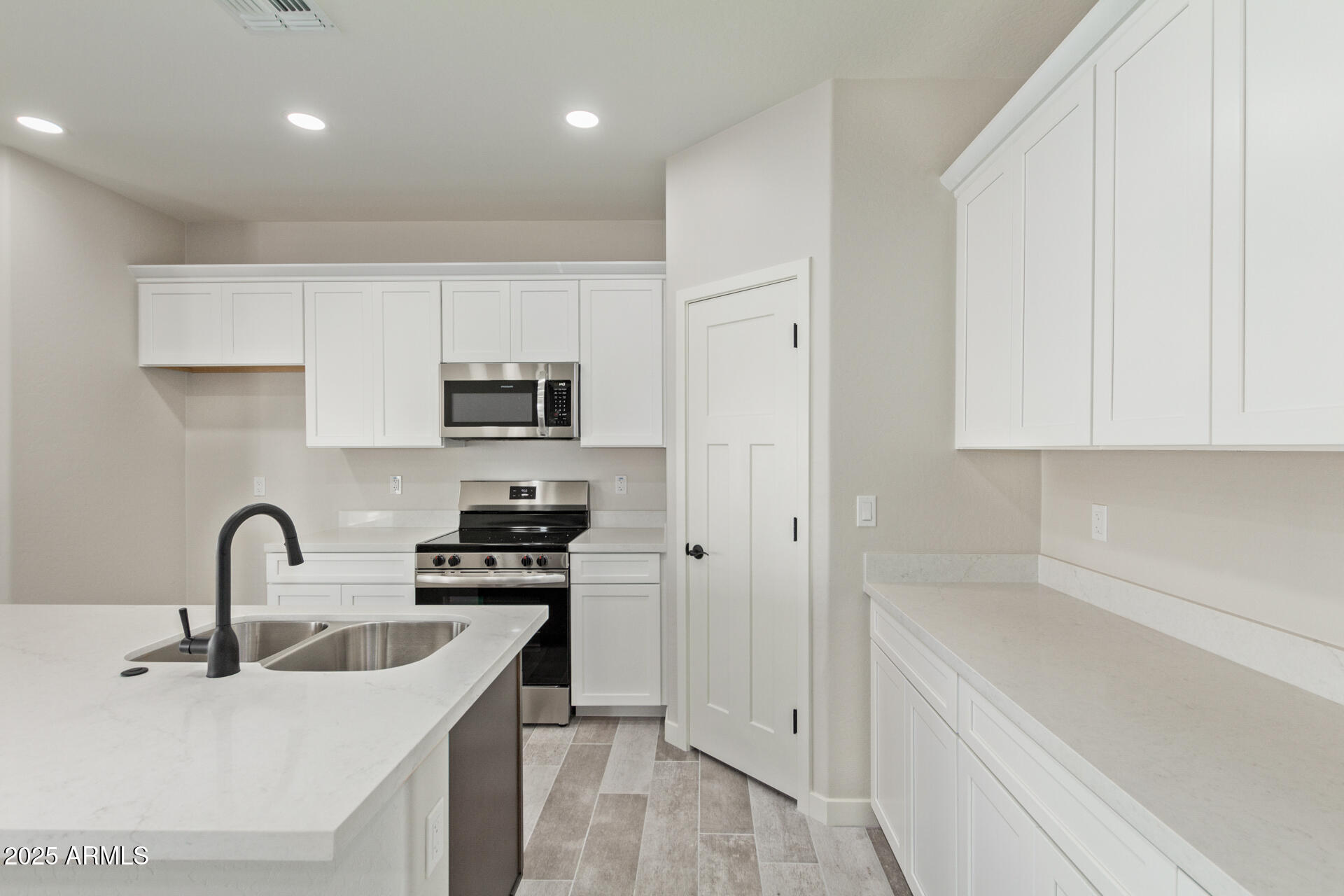 15220 South Diablo Road Arizona City, AZ 85123 - Photo 6 of 32 a kitchen with stainless steel appliances granite countertop a sink a stove and a refrigerator