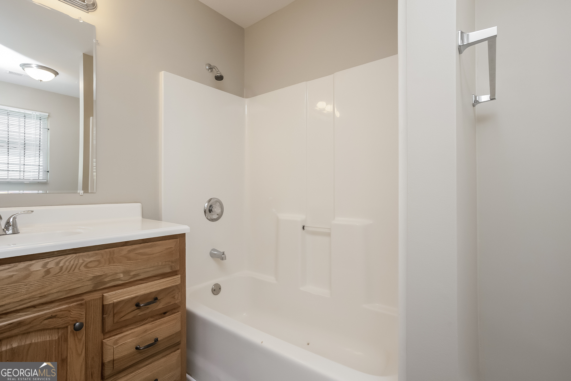 95 Howell Drive Southwest Atlanta, GA 30331 - Photo 12 of 17 a bathroom with a granite countertop sink a mirror and a bathtub