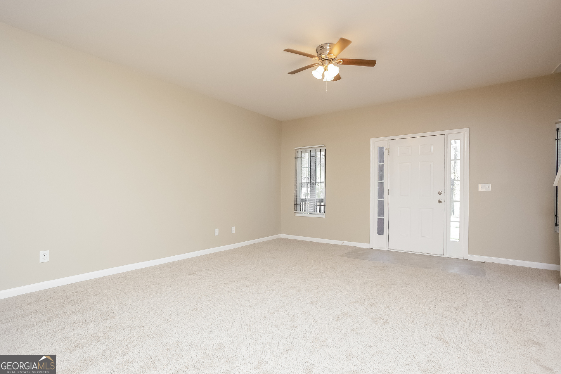 95 Howell Drive Southwest Atlanta, GA 30331 - Photo 3 of 17 an empty room with windows and fan