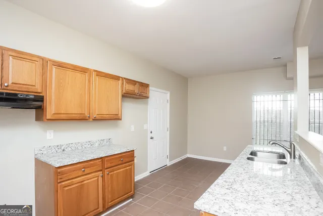 a kitchen with stainless steel appliances granite countertop a sink stove and cabinets