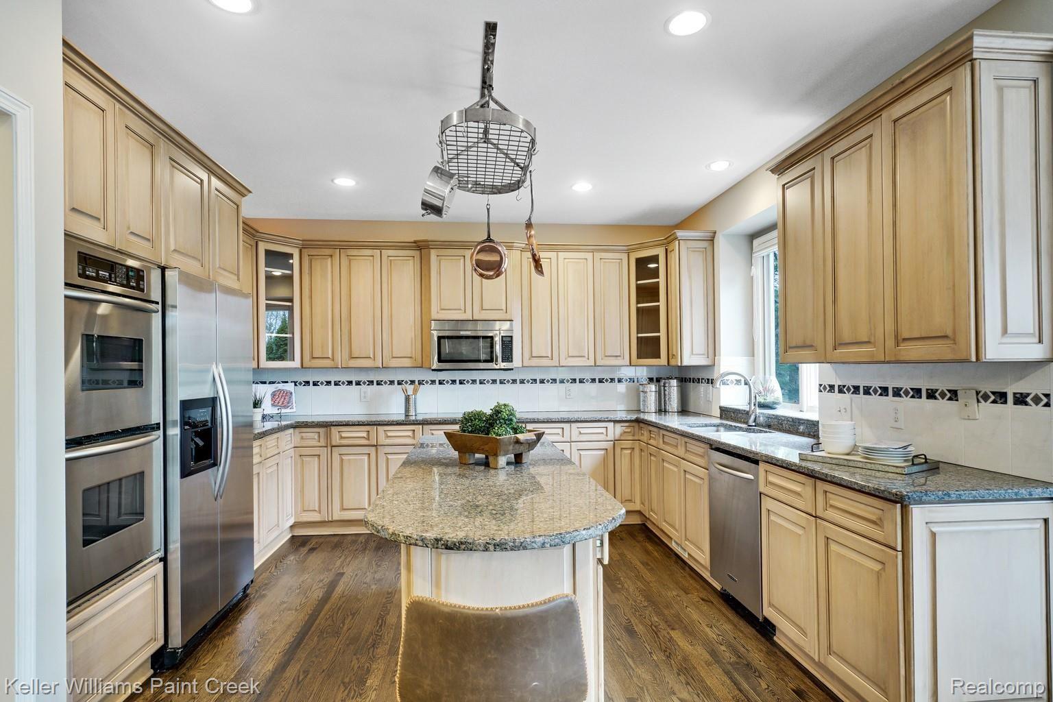 3473 Moceri Court Rochester, MI 48306 - Photo 27 of 58 Gourmet Kitchen with pot rack, large island and stainless steel appliances