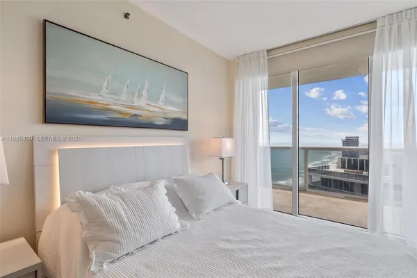 a bedroom with a bed and a large mirror