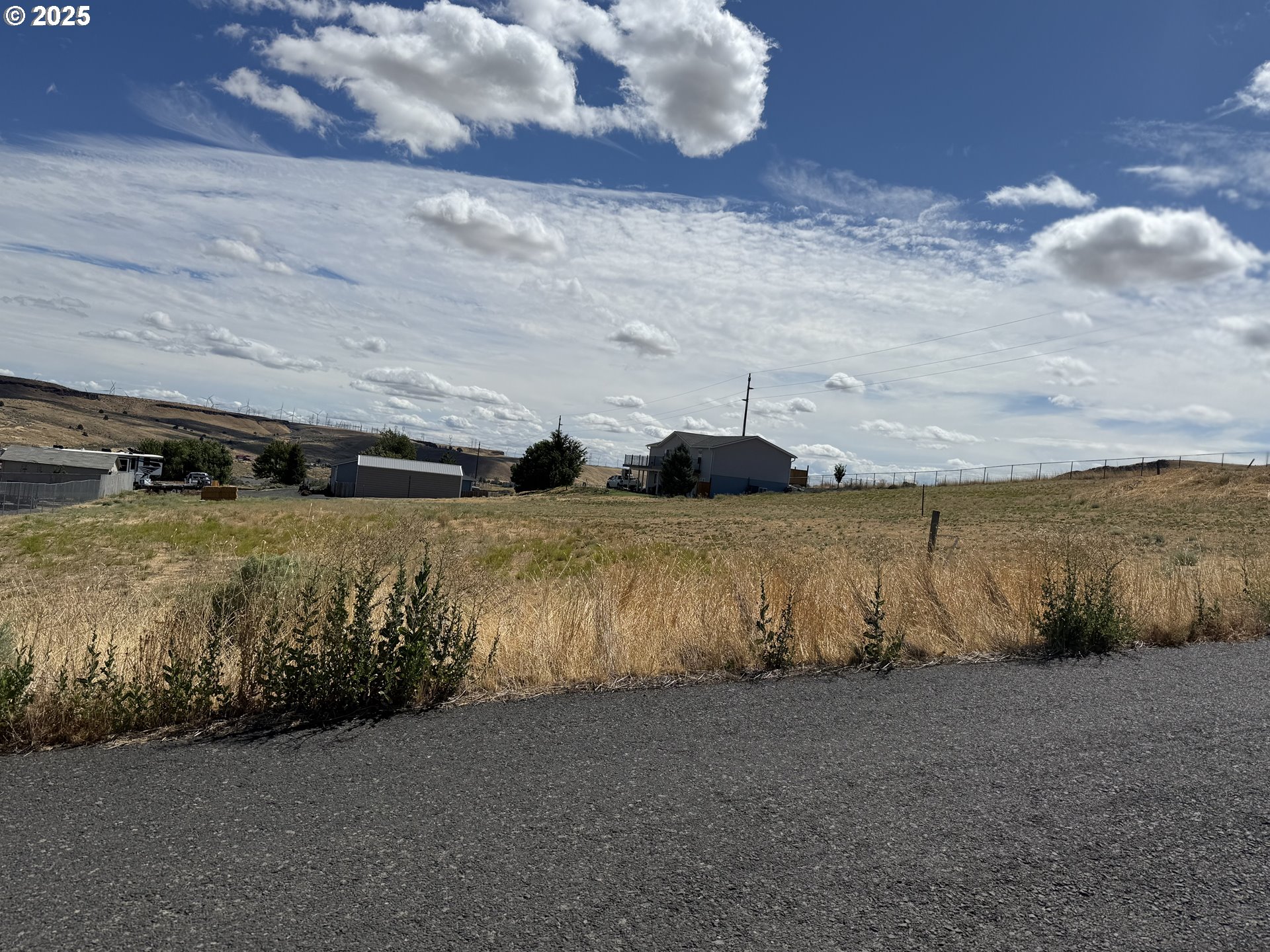 a view of a field of grass and mountain view