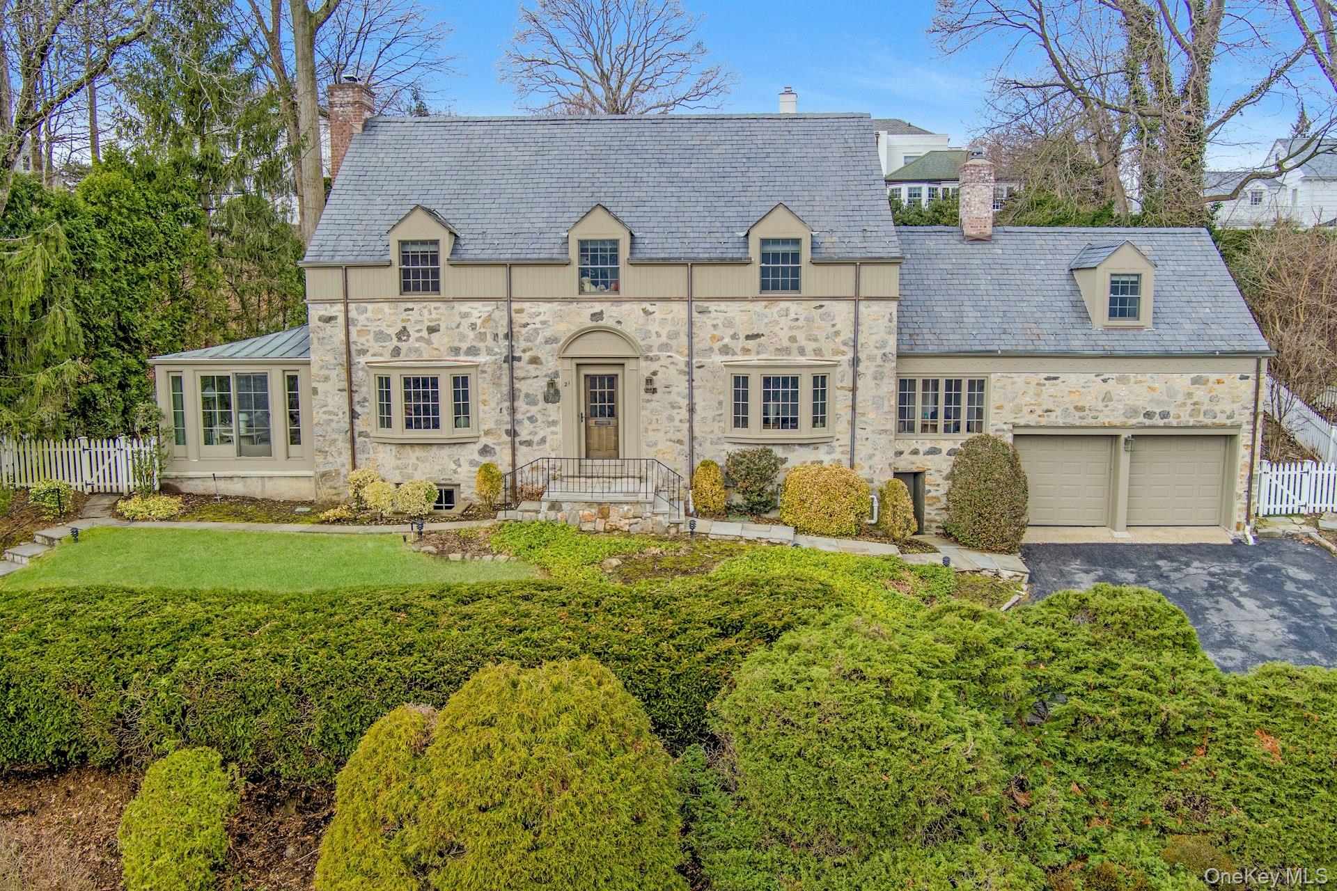 An elegant Crane Berkley residence with striking curb appeal, blending classic architecture with a fresh, sophisticated aesthetic and a picturesque view of the pond and park.