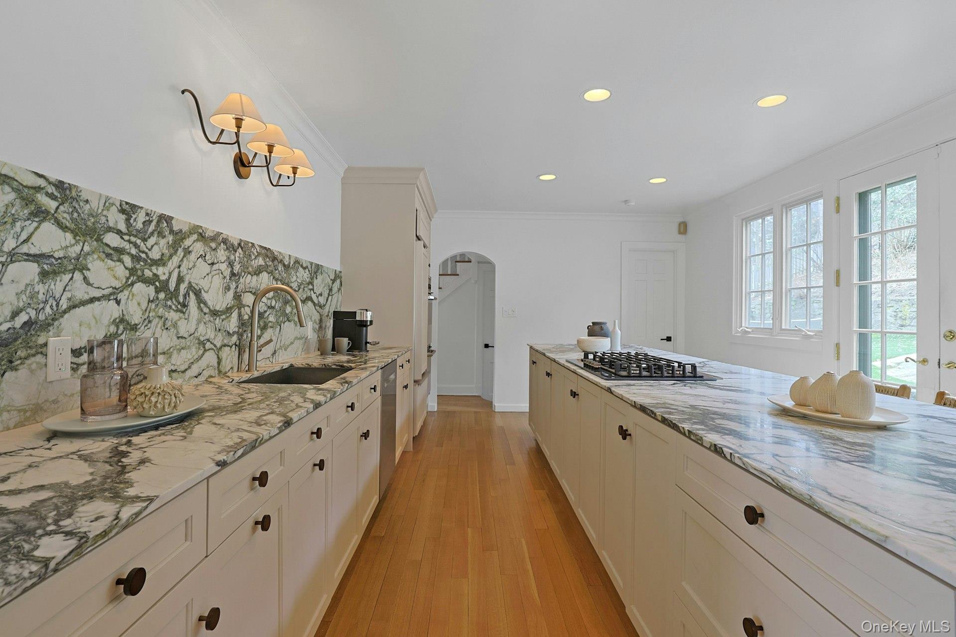 21 Tisdale Road Scarsdale, NY 10583 - Photo 13 of 40 Fabulous marble countertops and backsplash enhance the home’s curated aesthetic, complemented by abundant custom built-in cabinetry.