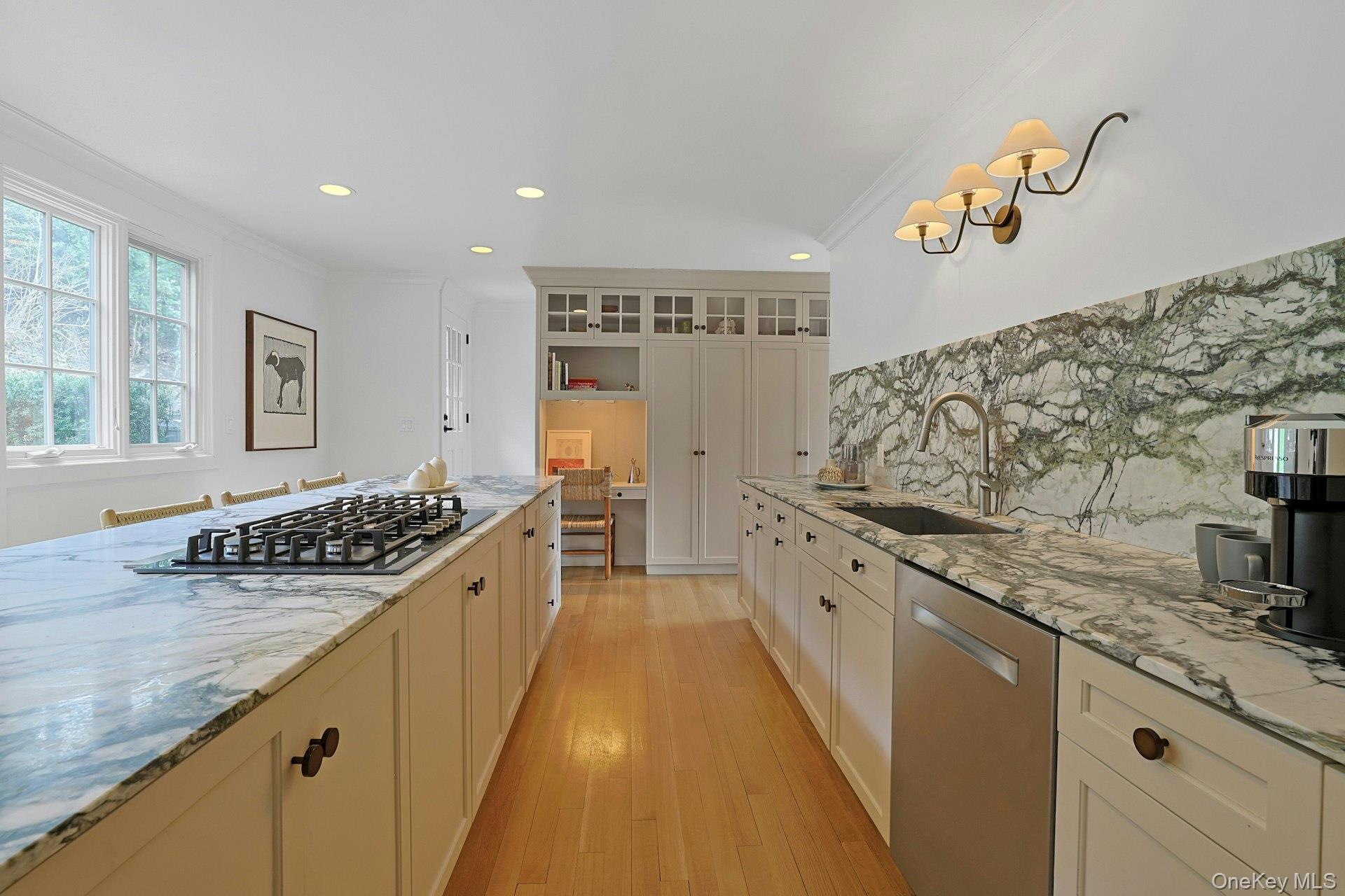 21 Tisdale Road Scarsdale, NY 10583 - Photo 14 of 40 Another perspective of the kitchen with views to the private backyard showcasing a built-in desk and several large pantry cabinets.