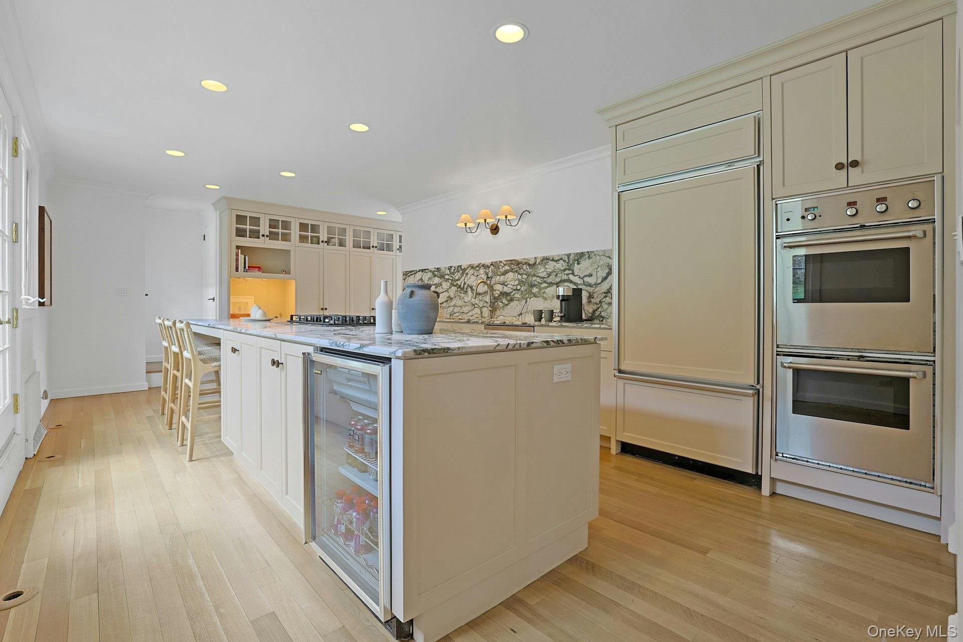 21 Tisdale Road Scarsdale, NY 10583 - Photo 15 of 40 This view highlights the suite of premium appliances, featuring the double wall ovens, paneled Sub-Zero fridge/freezer and the beverage fridge.