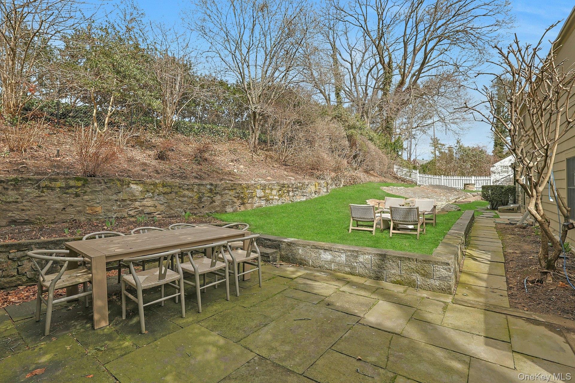 21 Tisdale Road Scarsdale, NY 10583 - Photo 30 of 40 Expansive stone patio offering multiple seating areas—perfect for outdoor dining, entertaining, and relaxed gatherings.