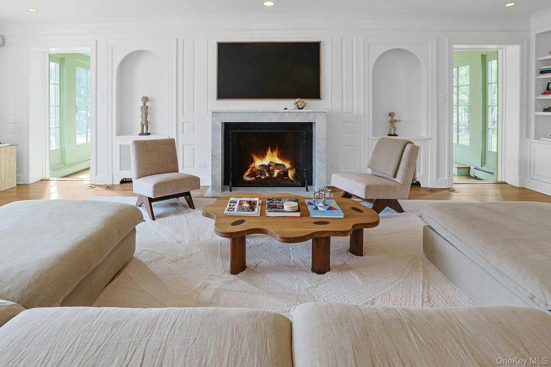 21 Tisdale Road Scarsdale, NY 10583 - Photo 5 of 40 Architectural detailing and custom built-ins accent the gas fireplace as the focal point of this beautifully scaled living room, while natural light beams in from the multiple exposures and the adjacent sunroom.