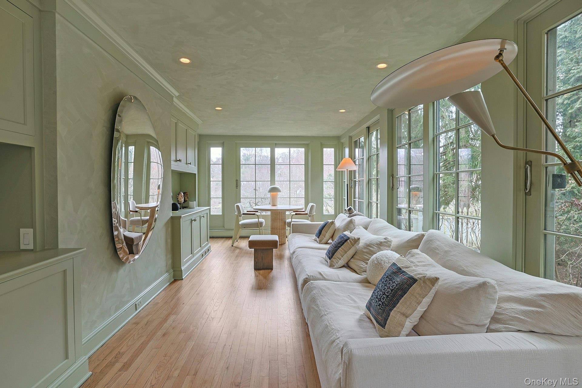 21 Tisdale Road Scarsdale, NY 10583 - Photo 9 of 40 Streaming sunlight fills the space, creating a bright and inviting setting to enjoy morning coffee or quiet moments while taking in the surrounding views.