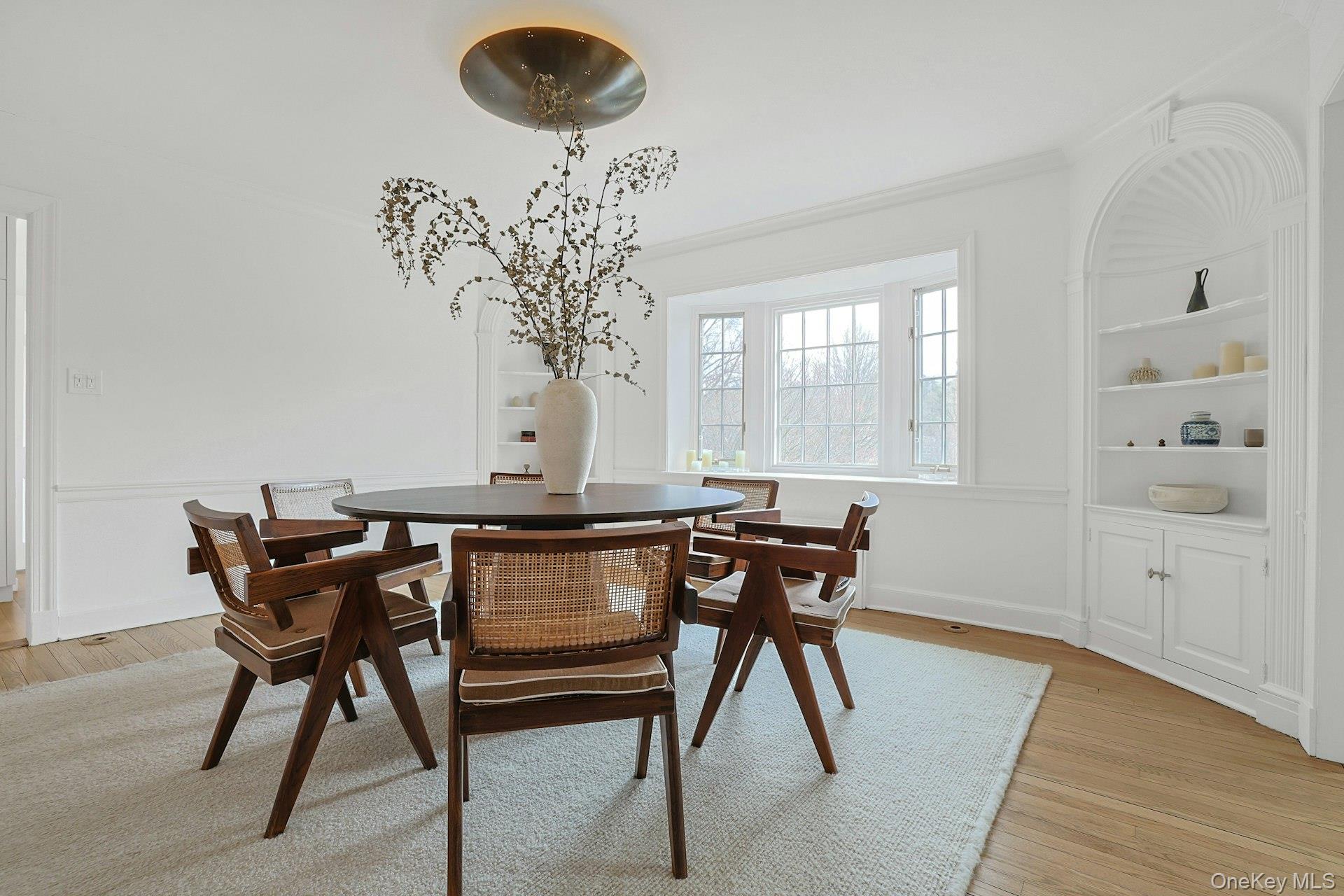 21 Tisdale Road Scarsdale, NY 10583 - Photo 10 of 40 Elegant dining room, with original built-ins, bay window overlooking the pond, and seamless flow into the kitchen.