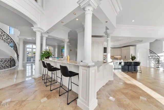 a living room with furniture a chandelier and a table