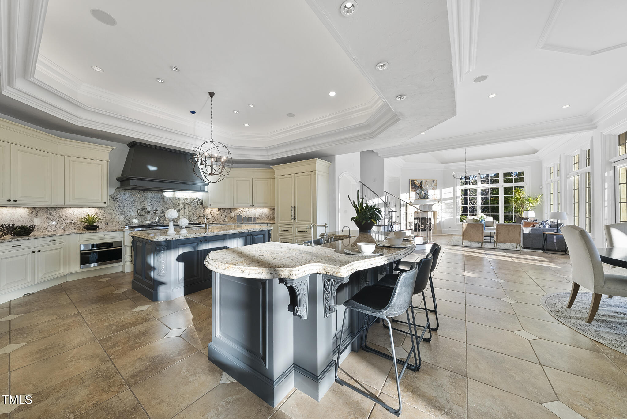 1404 Barony Lake Way Raleigh, NC 27614 - Photo 15 of 52 a kitchen with stainless steel appliances kitchen island granite countertop a table chairs sink and cabinets