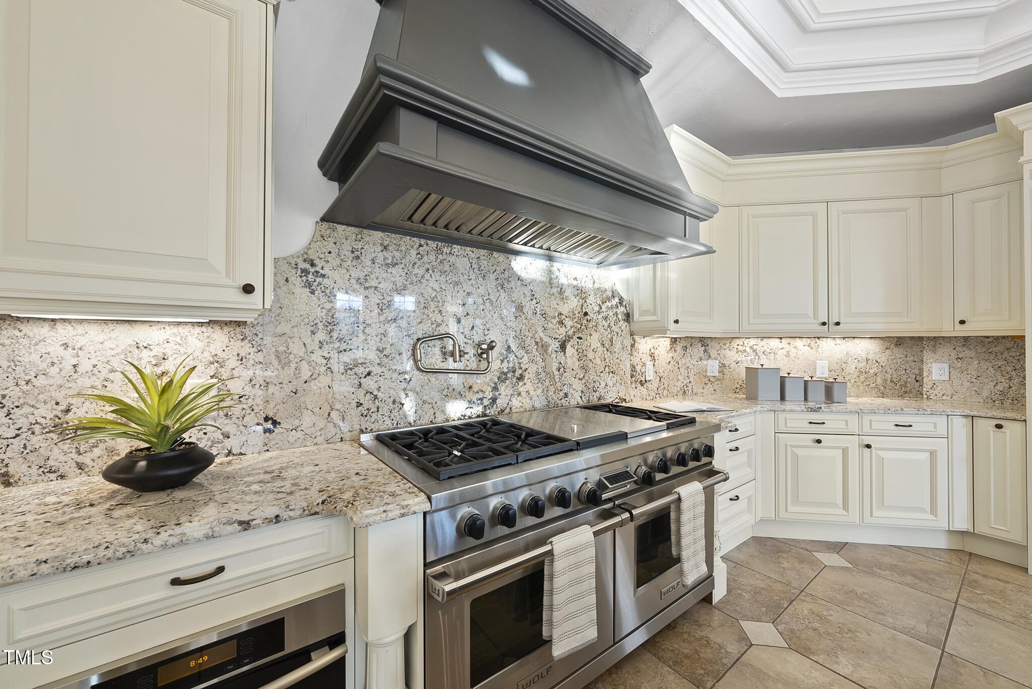 1404 Barony Lake Way Raleigh, NC 27614 - Photo 17 of 52 a kitchen with stainless steel appliances granite countertop a stove a sink and white cabinets