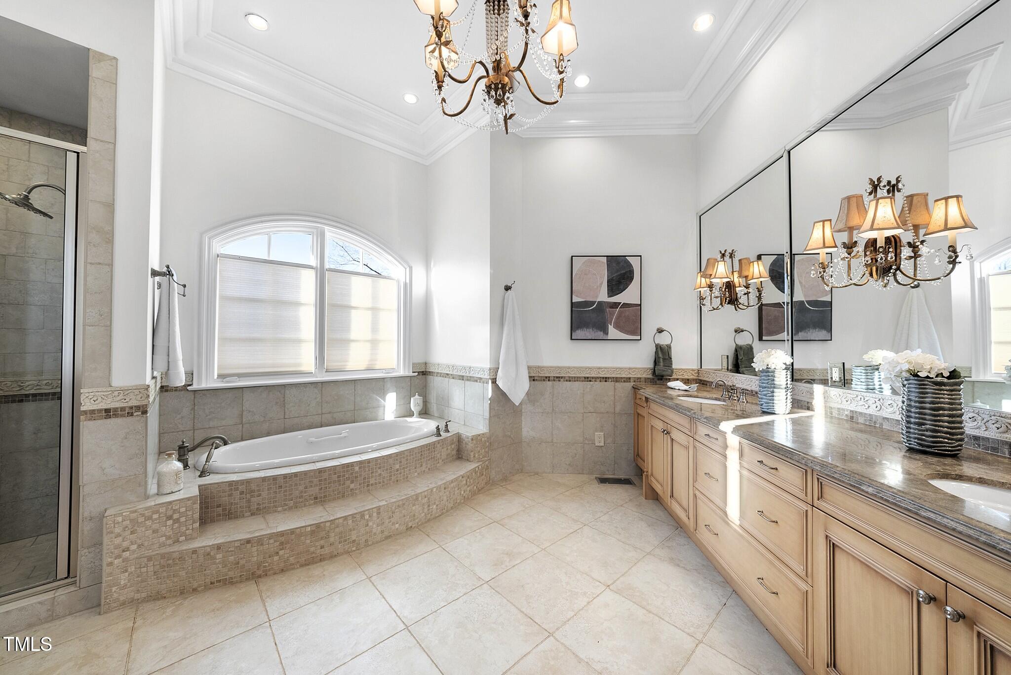 1404 Barony Lake Way Raleigh, NC 27614 - Photo 26 of 52 a spacious bathroom with a granite countertop tub a double vanity sink a vanity and a large mirror