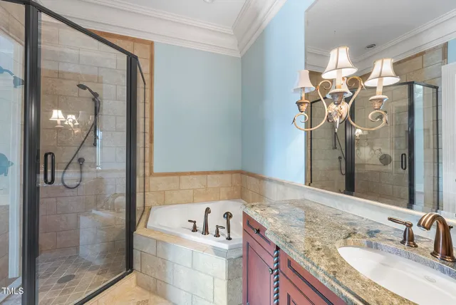 a bathroom with a granite countertop sink a large mirror and a shower