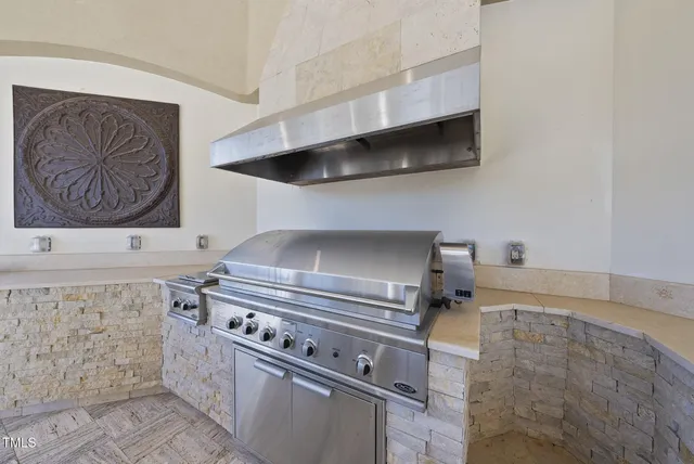 a view of an empty room with a fireplace and a large window