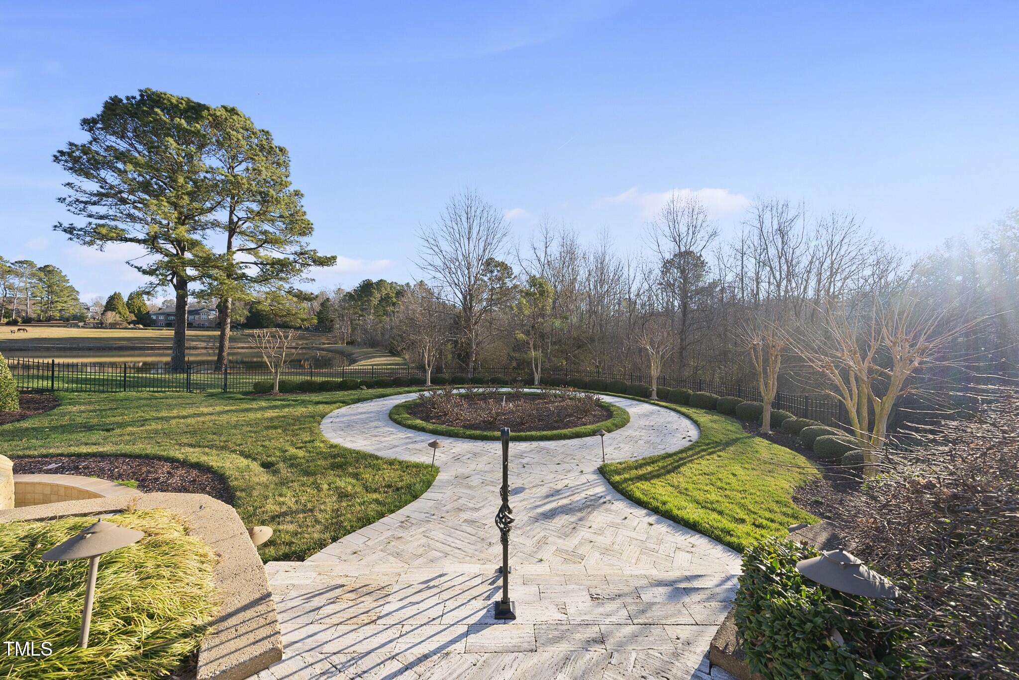 1404 Barony Lake Way Raleigh, NC 27614 - Photo 42 of 52 a view of a backyard with couches plants and large trees