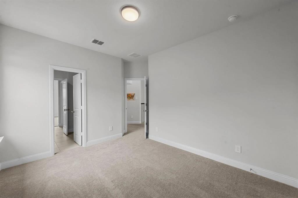 10969 Coastal Violet Road Frisco, TX 75035 - Photo 23 of 30 Unfurnished bedroom featuring light carpet and baseboards