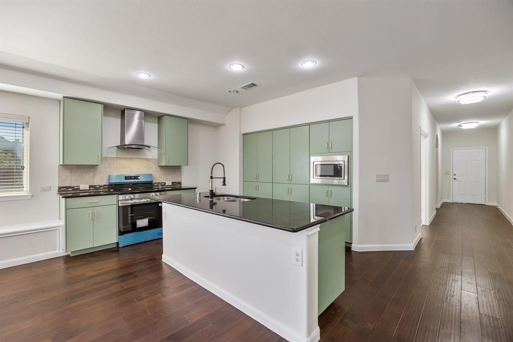 4104 Gaillardia Way Forney, TX 75126 - Photo 12 of 34 a kitchen with kitchen island granite countertop a sink and refrigerator