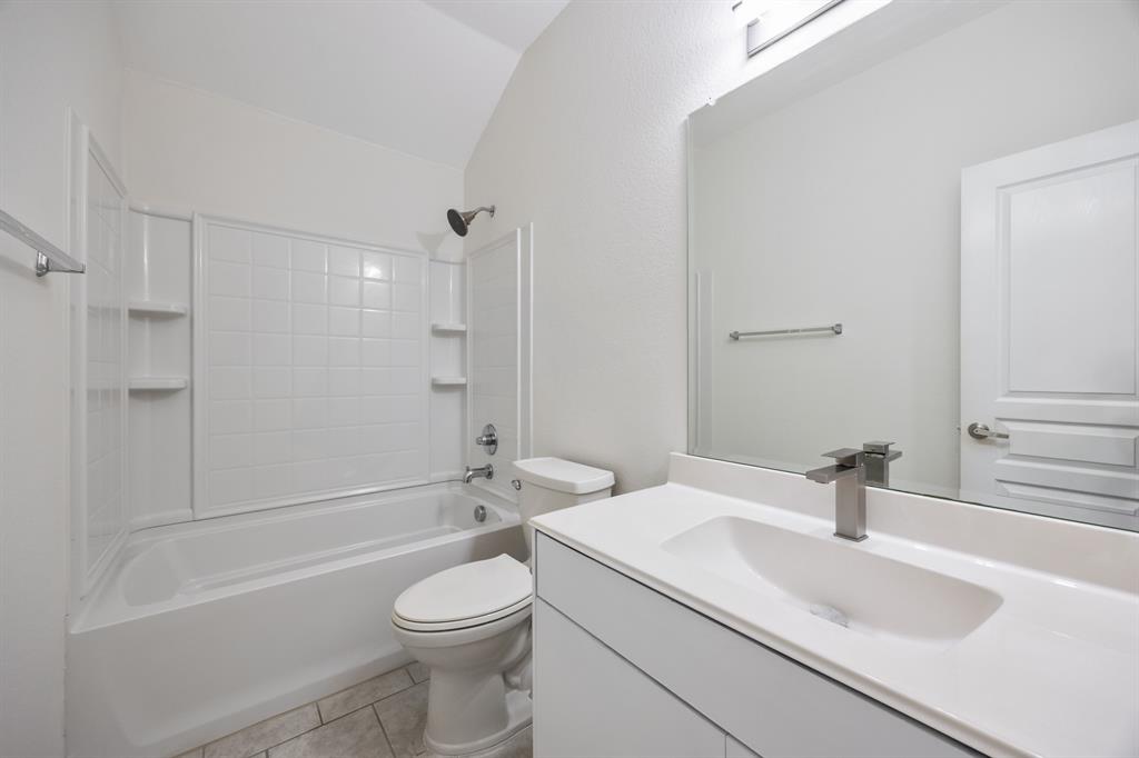 4104 Gaillardia Way Forney, TX 75126 - Photo 20 of 34 a bathroom with a sink a toilet and a bathtub