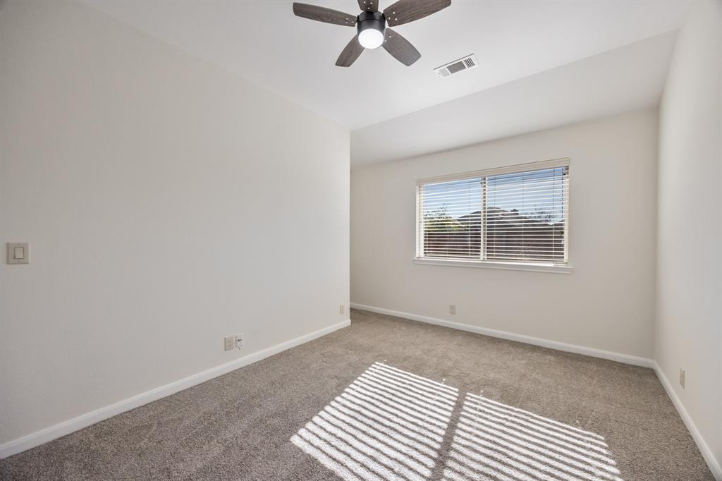 4104 Gaillardia Way Forney, TX 75126 - Photo 24 of 34 an empty room with a window and ceiling fan