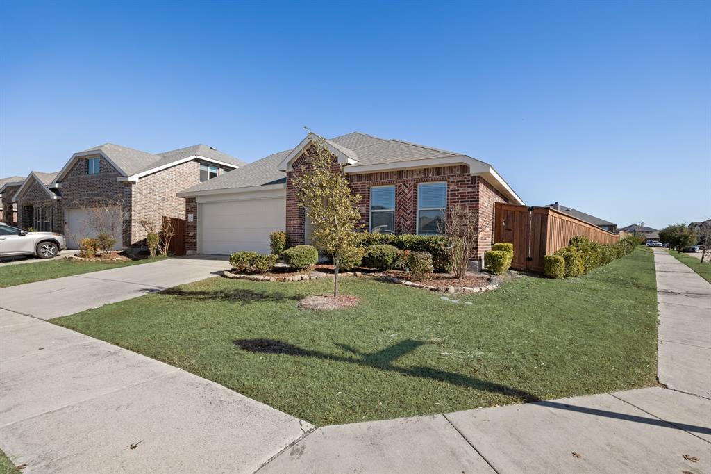4104 Gaillardia Way Forney, TX 75126 - Photo 3 of 34 a front view of a house with a garden