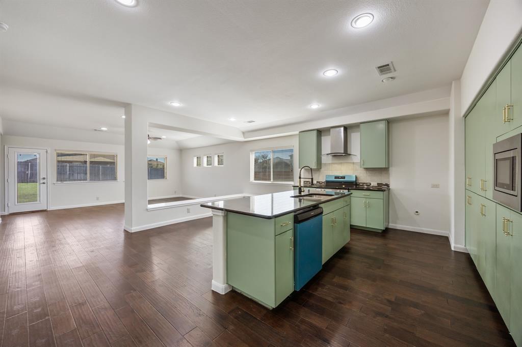 4104 Gaillardia Way Forney, TX 75126 - Photo 4 of 34 a kitchen with counter top space and wooden floor