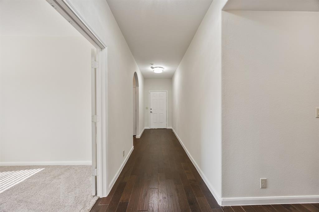 4104 Gaillardia Way Forney, TX 75126 - Photo 6 of 34 a view of a hallway with wooden floor
