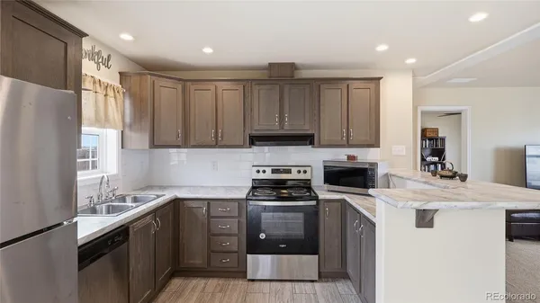 a kitchen with a sink a stove and refrigerator