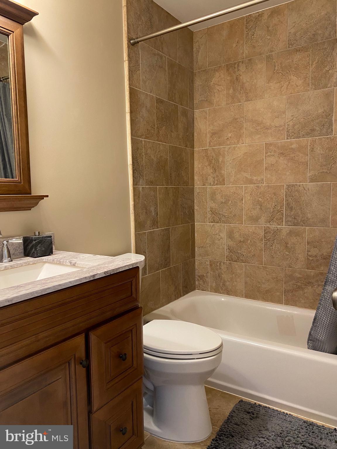 37715 Apache Road Charlotte Hall, MD 20622 - Photo 12 of 35 a bathroom with a granite countertop bathtub shower sink vanity and toilet