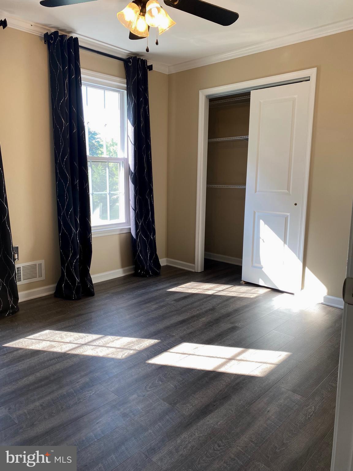 37715 Apache Road Charlotte Hall, MD 20622 - Photo 13 of 35 an empty room with wooden floor and windows