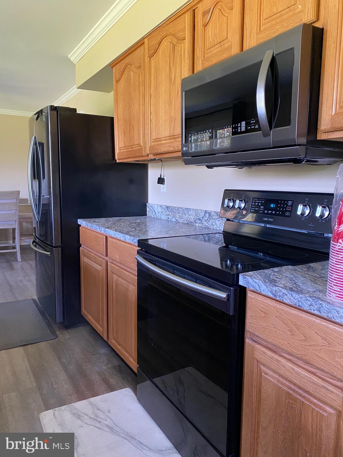 37715 Apache Road Charlotte Hall, MD 20622 - Photo 6 of 35 a kitchen with a stove microwave and sink