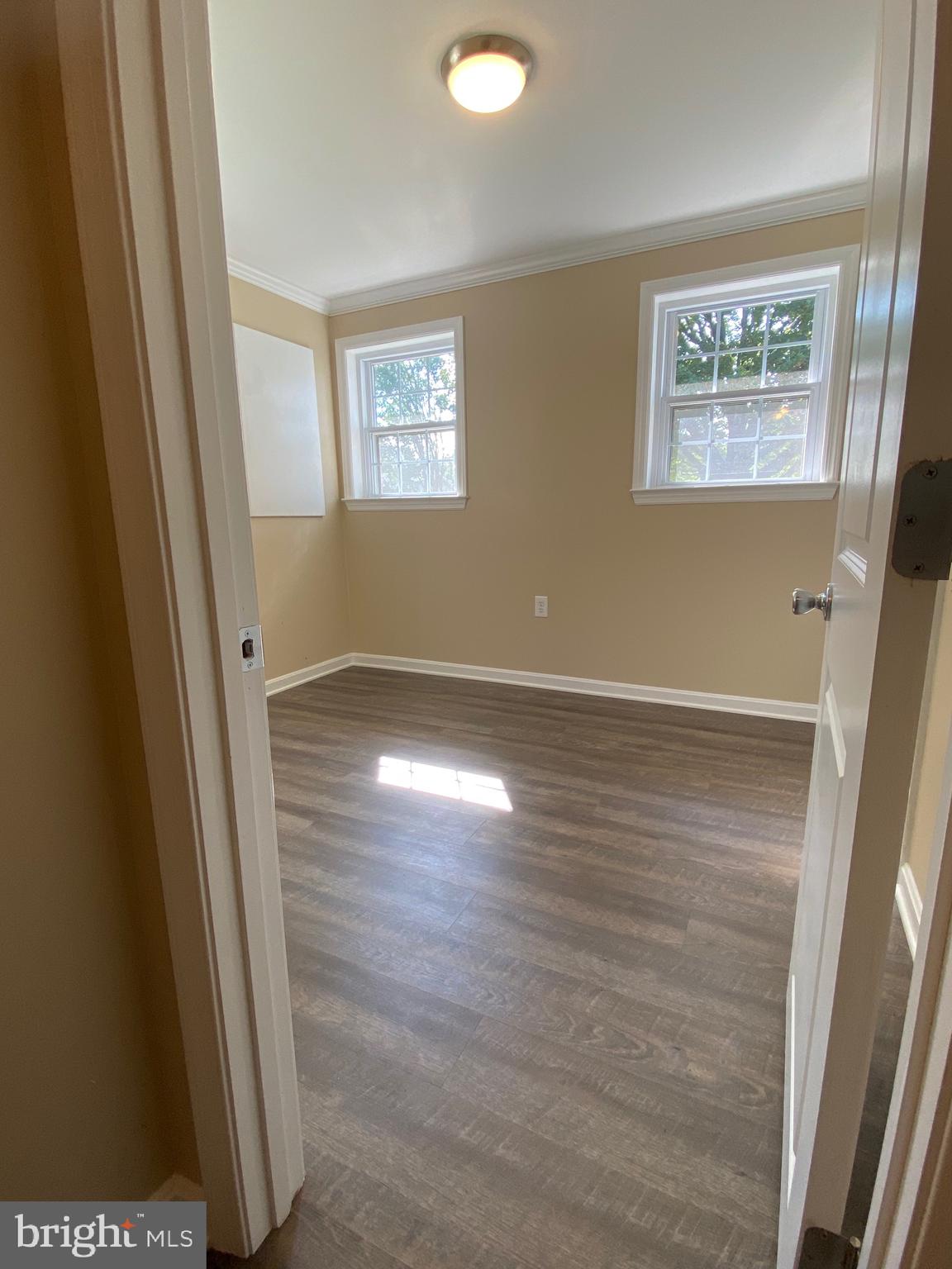 37715 Apache Road Charlotte Hall, MD 20622 - Photo 7 of 35 a view of an empty room with wooden floor and a window