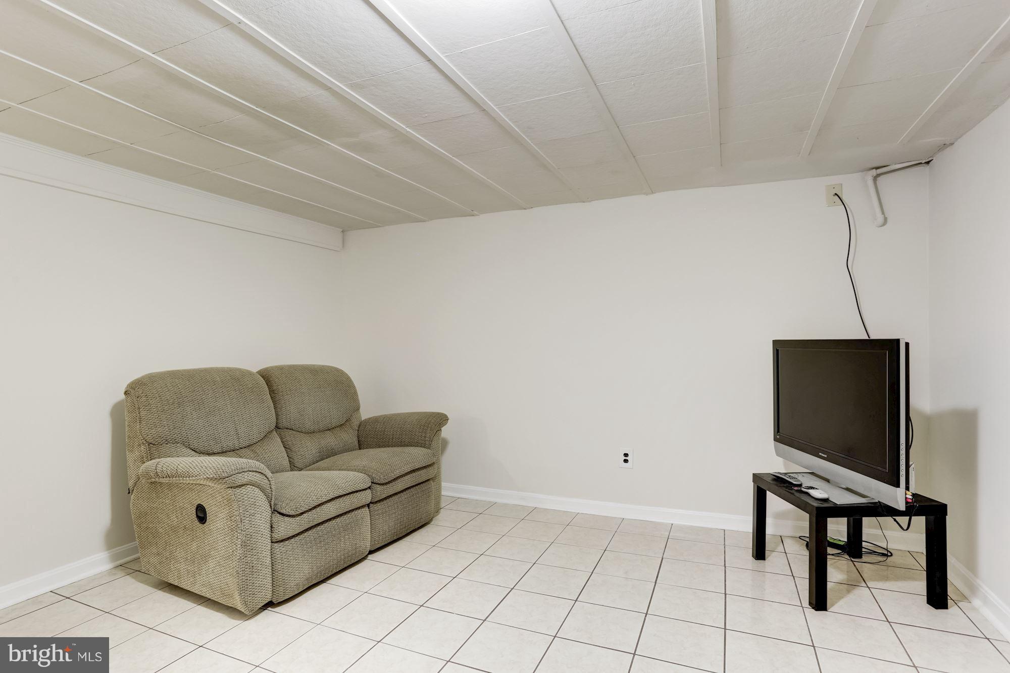 12610 Gould Road Silver Spring, MD 20906 - Photo 22 of 30 a living room with furniture and a flat screen tv