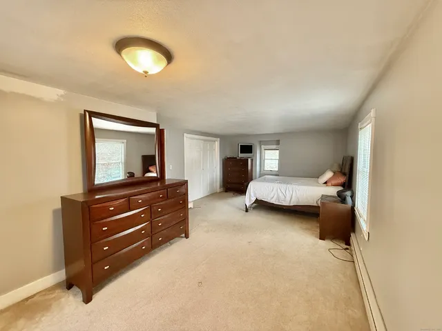 a bedroom with a bed and a television