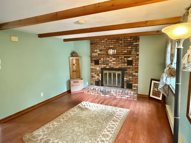 a view of a livingroom with wooden floor and a furniture