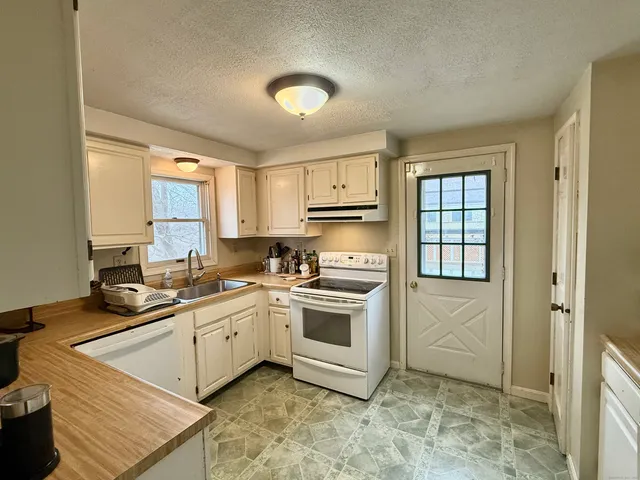 a kitchen with a sink stove and cabinets