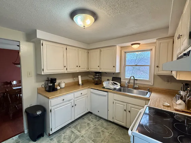 a kitchen with a sink stove and cabinets